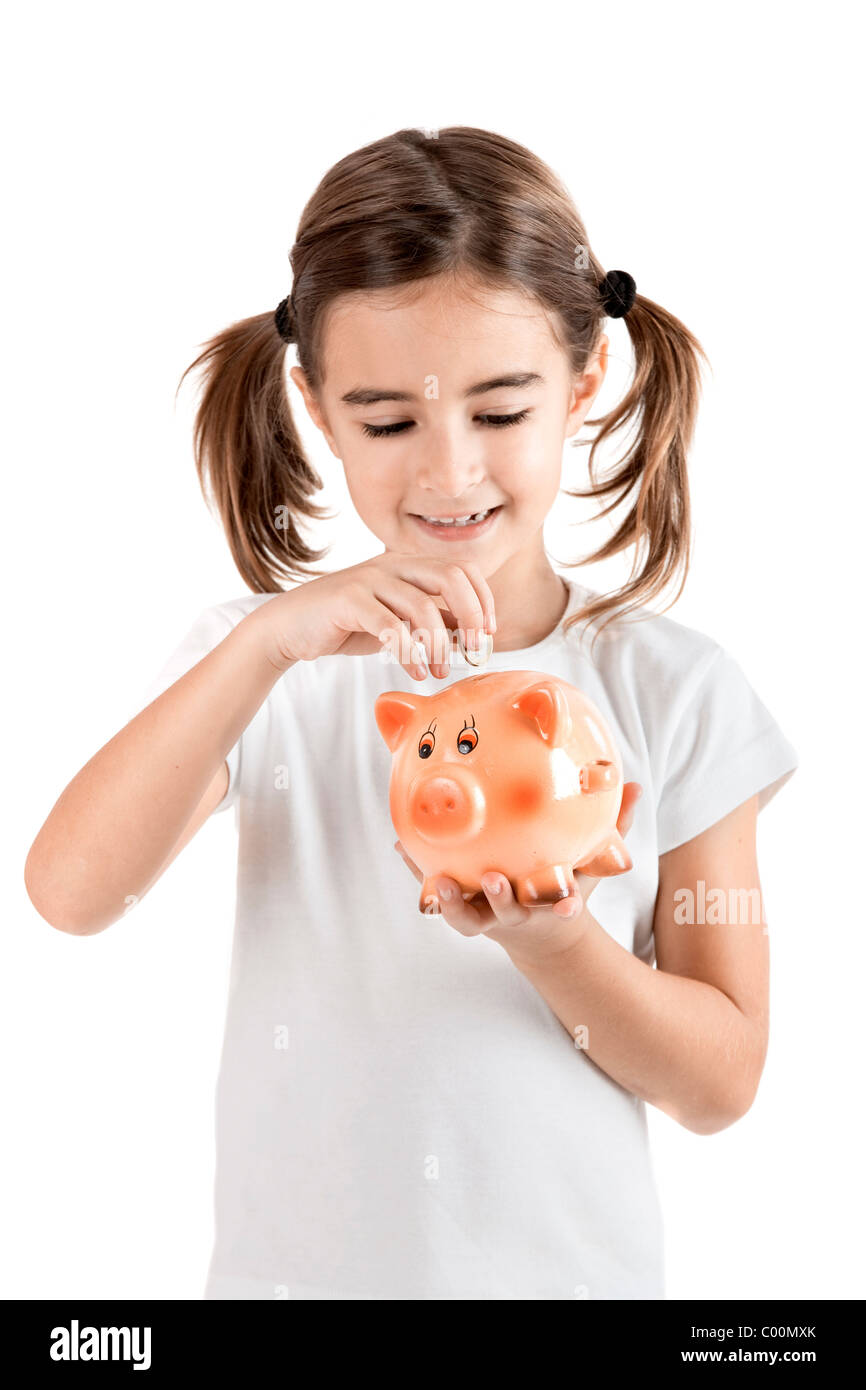 Little girl holding a piggy-bank and inserting a one euro coin Stock ...