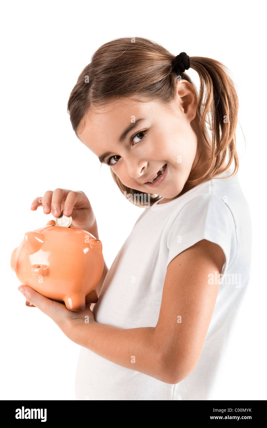 Little girl holding a piggy-bank and inserting a one euro coin Stock ...