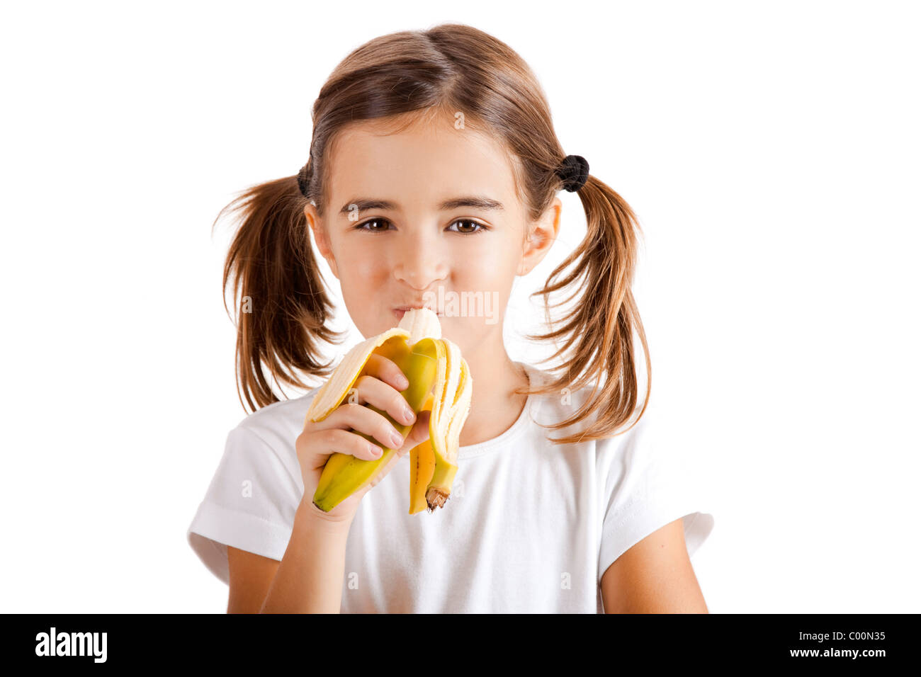 Portrait of a beautiful little girl eating a banana Stock Photo Alamy