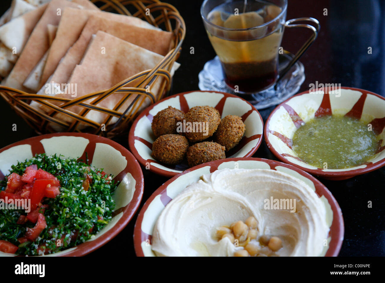 Typical breakfast of hummus, falafel salad and pita bread, Aqaba, Jordan. Stock Photo
