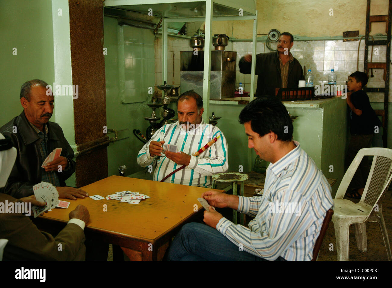 Men playing cards at a traditional cafe on Mayden street, Salt, Jordan. Stock Photo