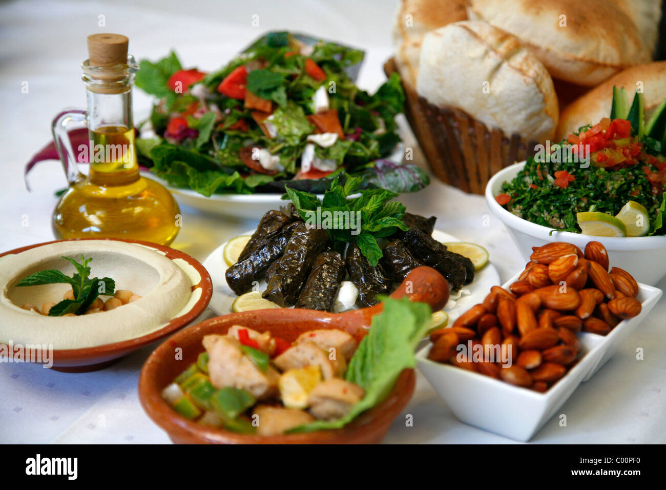 Mezzes (hummus, salad, cow testicles, almonds, tabbouleh)at the Lebanese House restaurant in Jerash, Jordan. Stock Photo