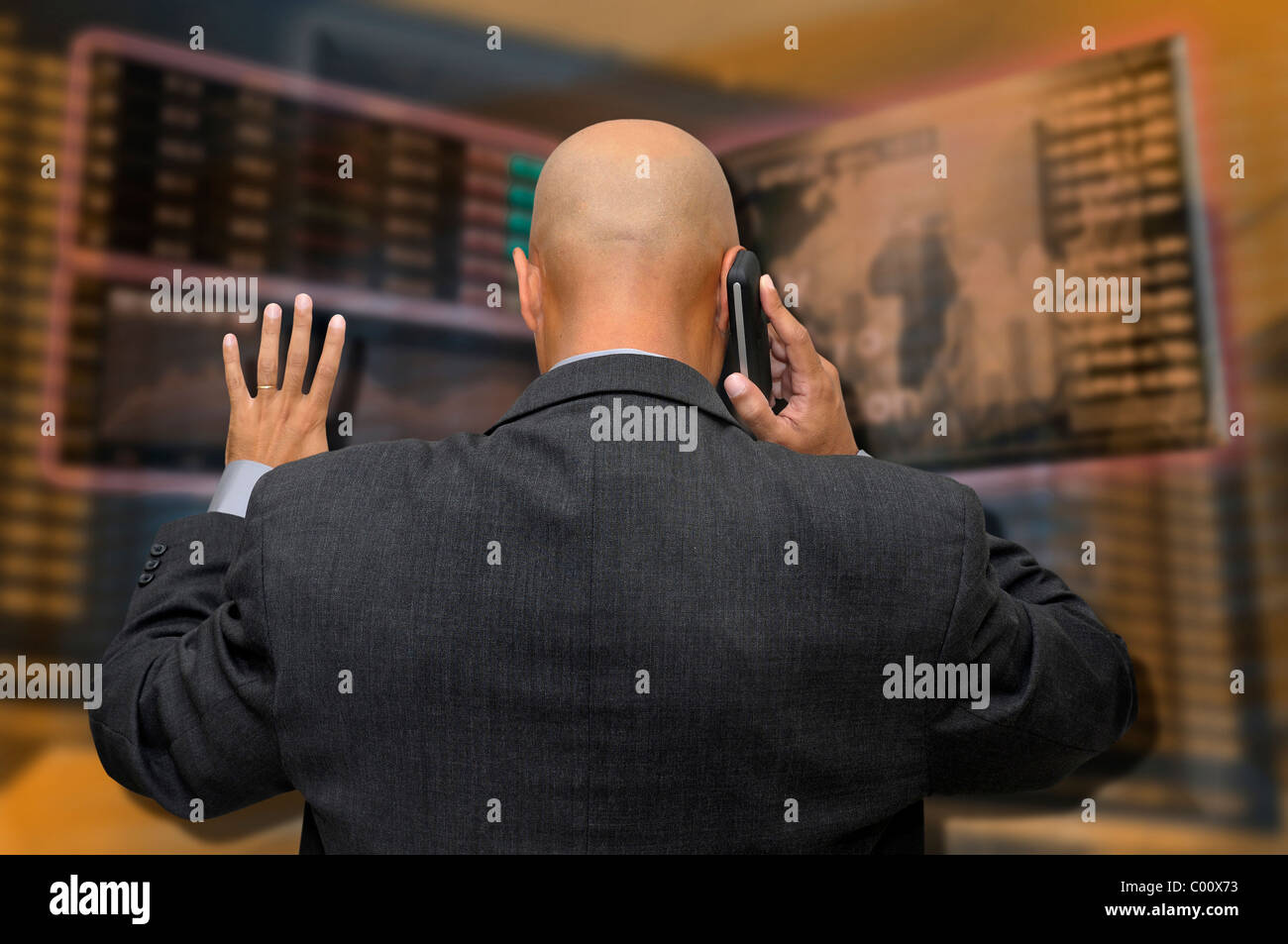 Businessman or stock broker at the phone in stock exchange Stock Photo