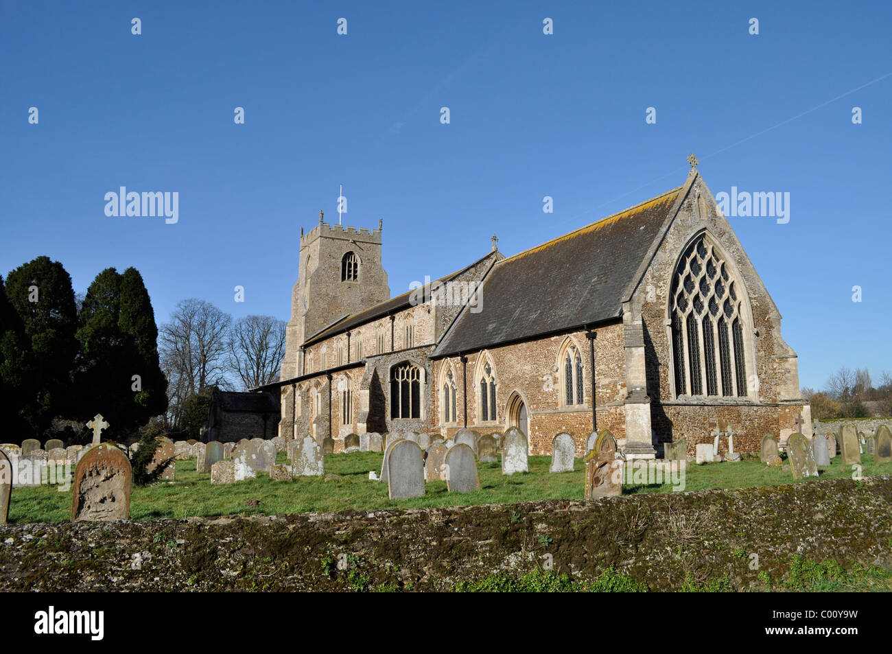 Old English churchyard in spring, St. Nicholas, Dersingham, Norman church site. Stock Photo