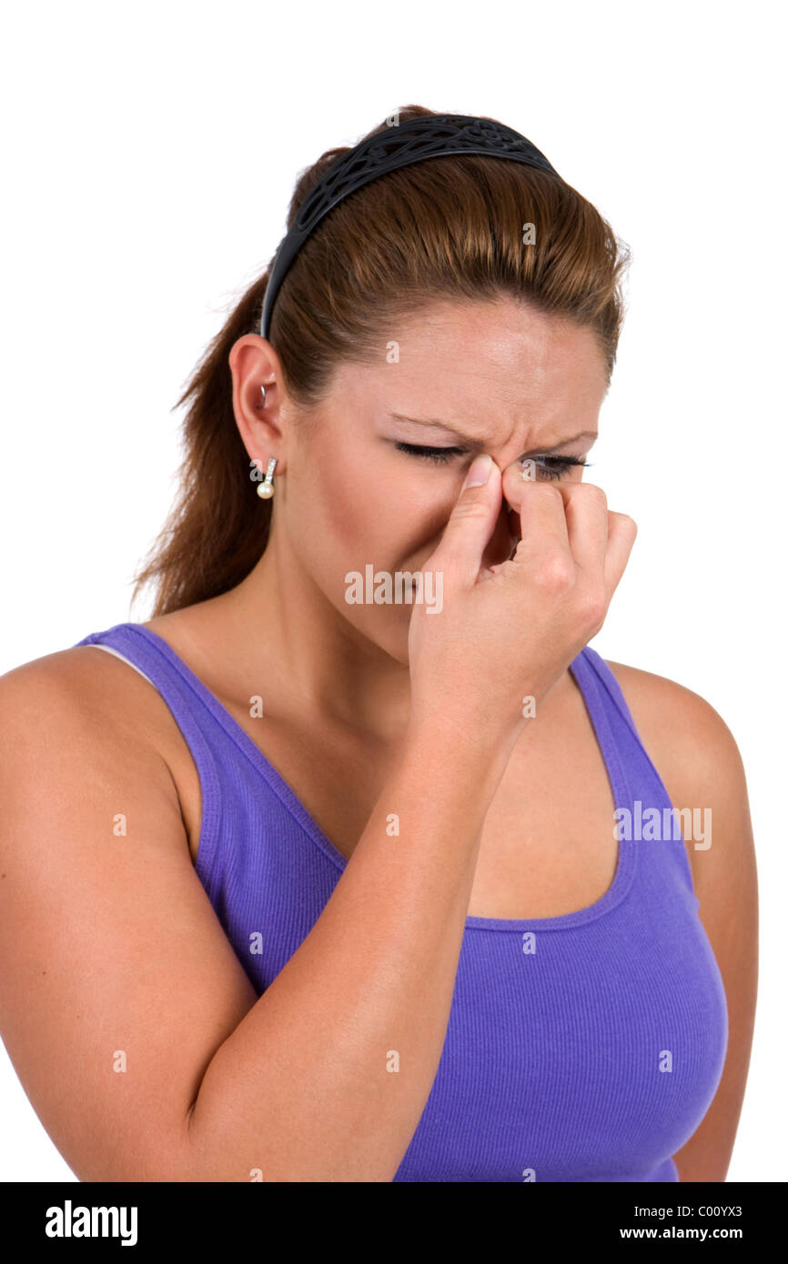 Woman holds the bridge of her nose suffering from sinus congestion. Stock Photo