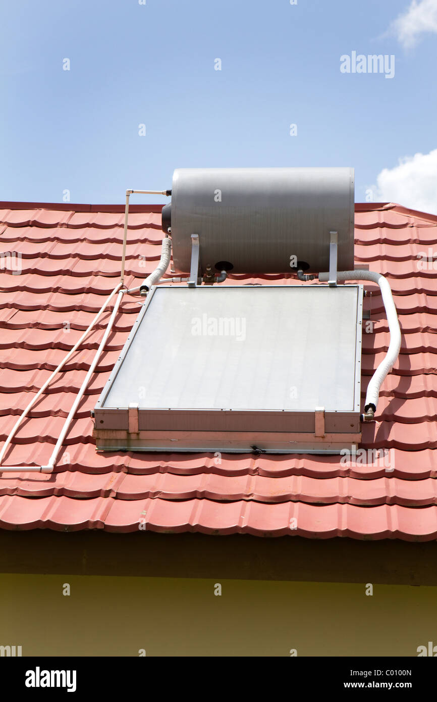 Solar water heater sits on the roof of a home in Manchester, Jamaica. Stock Photo