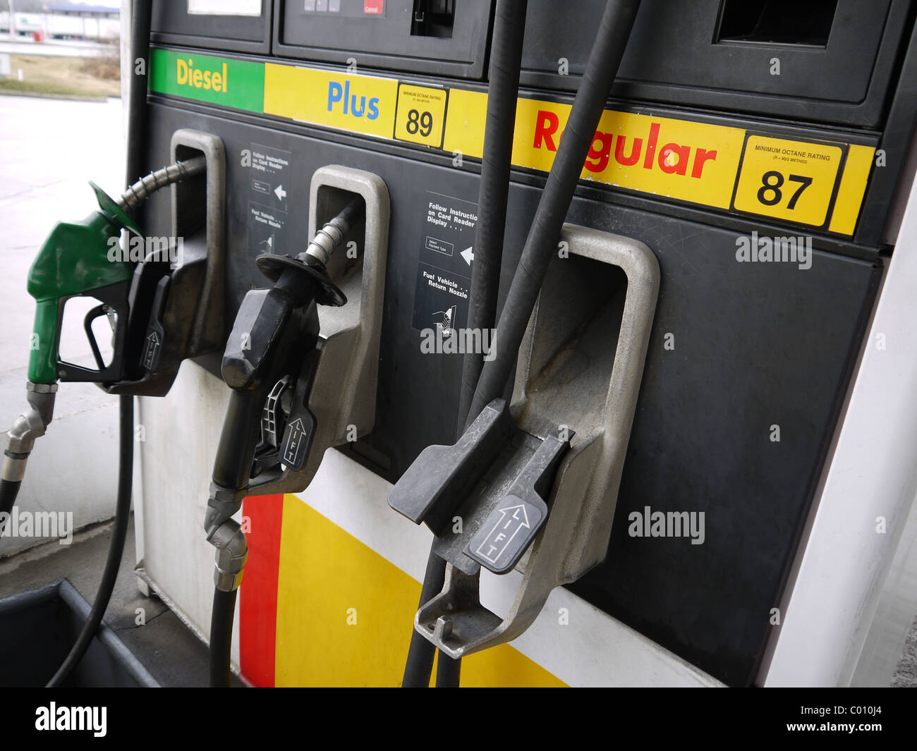 Close-up of gas pump nozzles at a gas station. Stock Photo