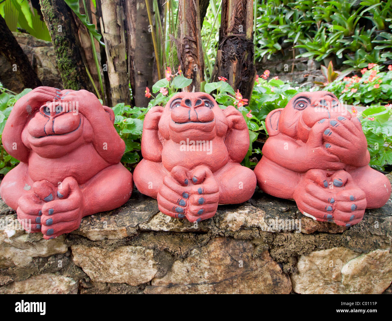 A three wild monkeys garden pottery, see no evil, hear no evil, speak no evil. Stock Photo