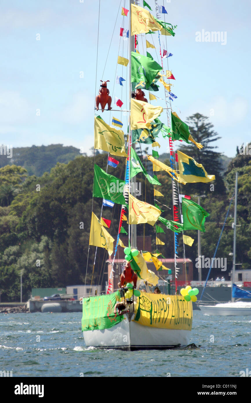 Australia Day celebrations on Sydney Harbour, New South Wales, Australia, a yacht is decorated with Australian colours of green and gold flags. Stock Photo
