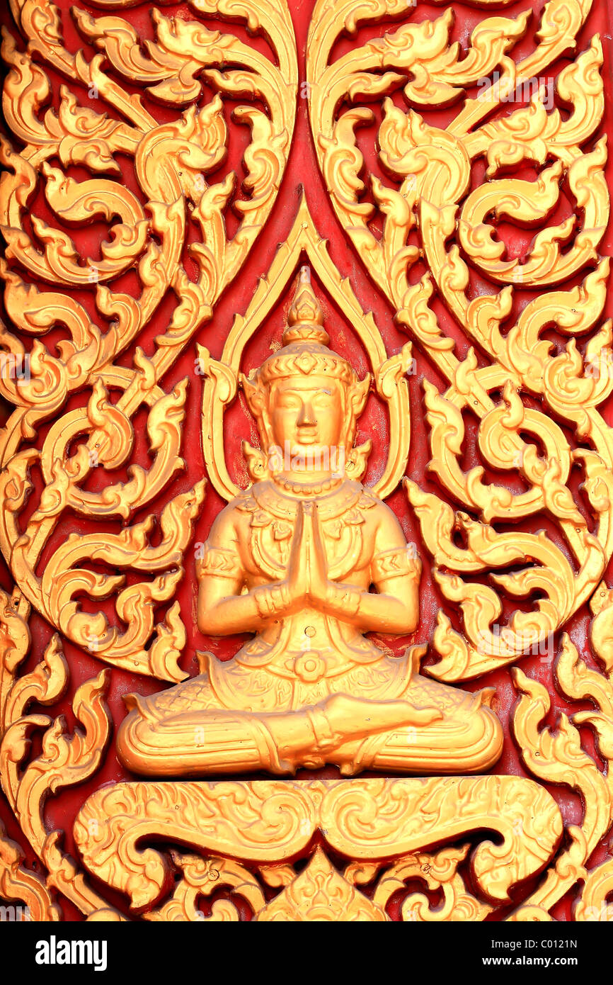 raditional thai style art carving at the door of temple Stock Photo
