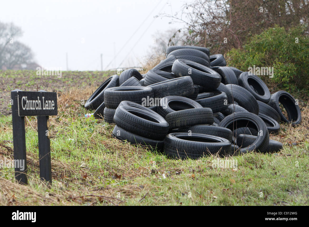 A pile of tyres dumped beside a countryside road in West Yorkshire, United Kingdom. Stock Photo