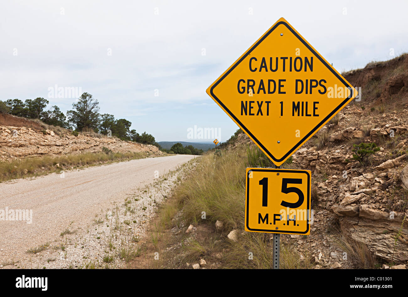 Caution Grade Dips next 1 mile 15 mph sign on dirt road Guadalupe mountains New Mexico USA Stock Photo