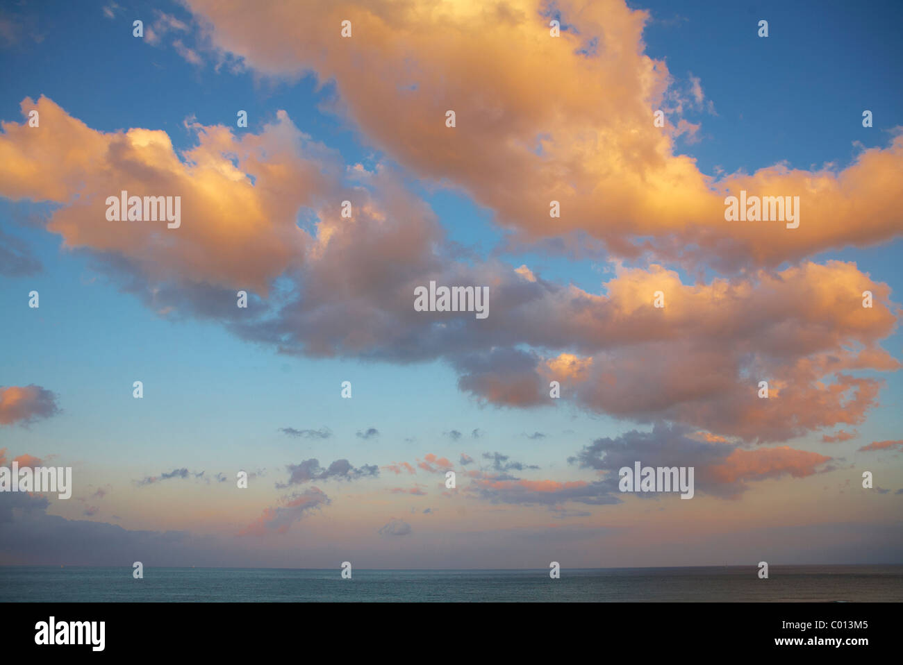 Blue sky with clouds in the evening light Stock Photo