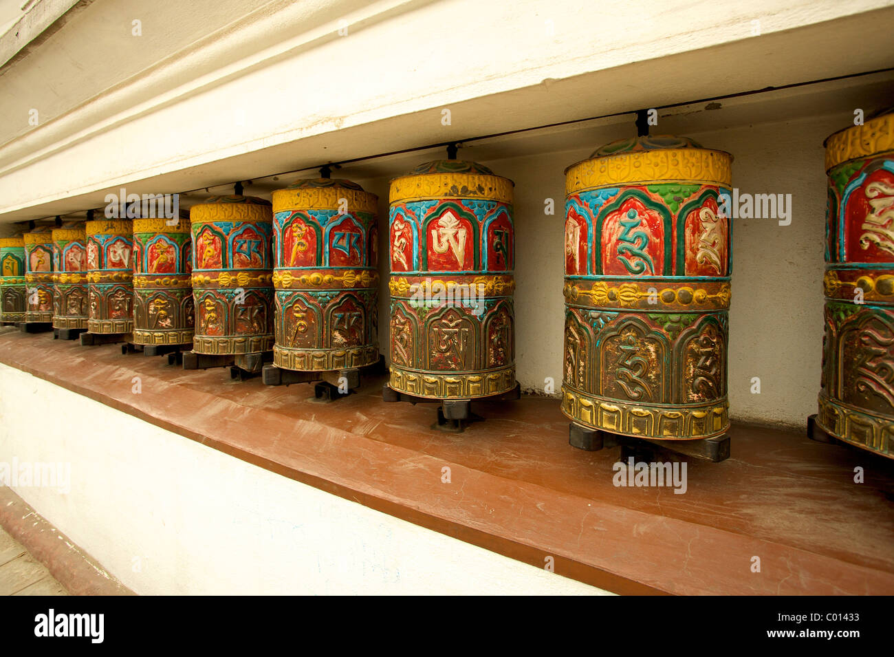 Buddhist prayer wheels on the exterior wall of the Swayambhunath Stupa ...