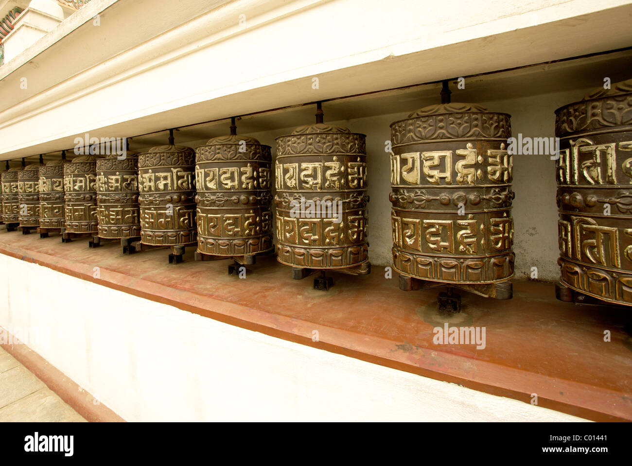 Buddhist prayer wheels on the exterior wall of the Swayambhunath Stupa ...