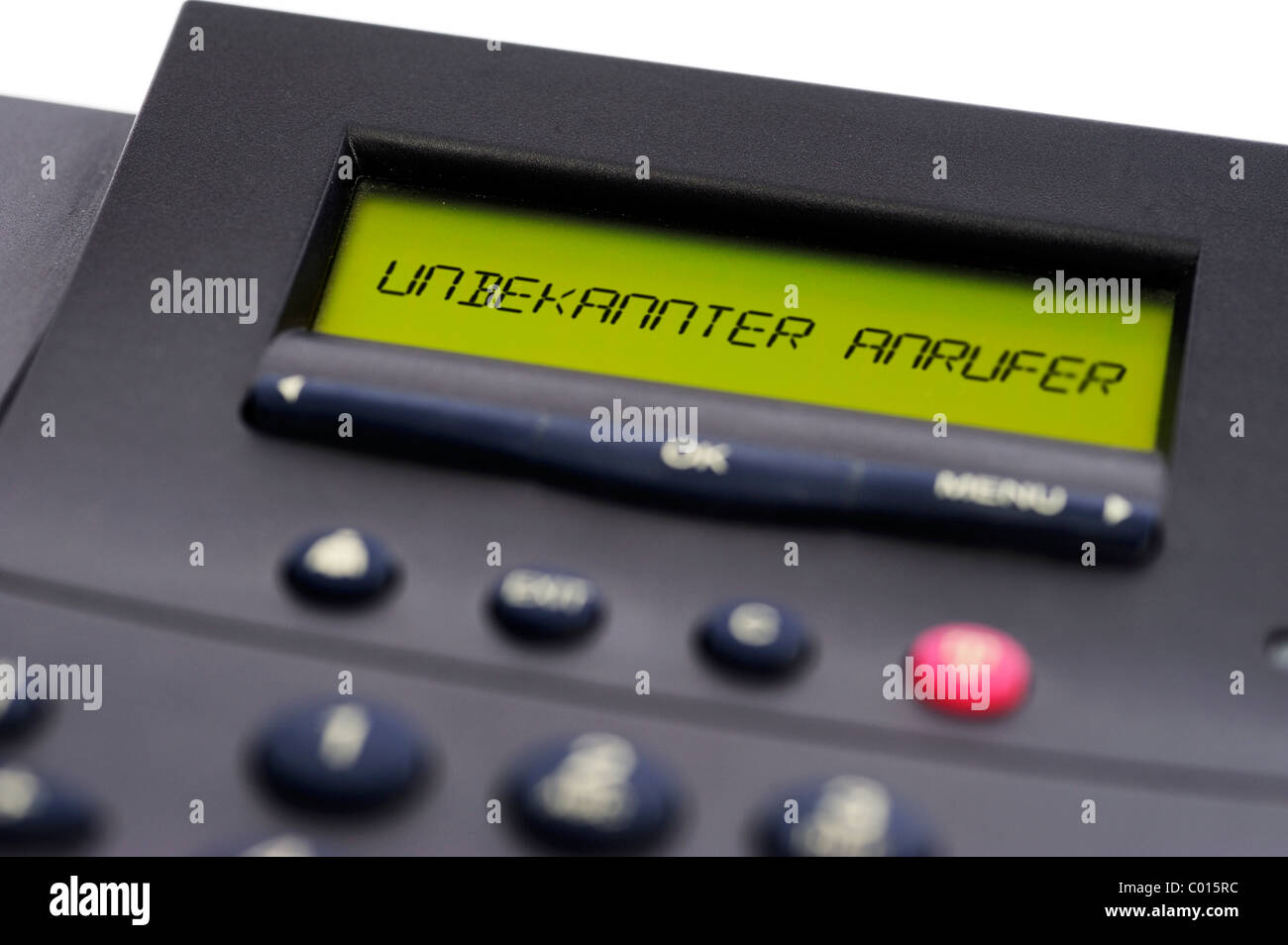 Display of a phone with text Unbekannter Anrufer or unknown caller, telephone advertising with suppressed telephone number Stock Photo