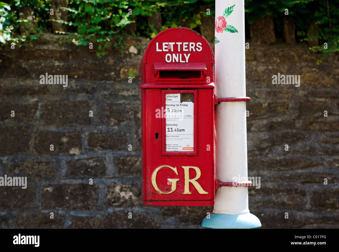 Post box on decorated lamp post Stock Photo Alamy