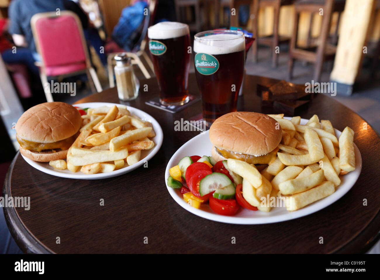 Burger with fries and Smithwick's beer in a pub in Shannonbridge, County Offaly, Leinster, Republic of Ireland, Europe Stock Photo