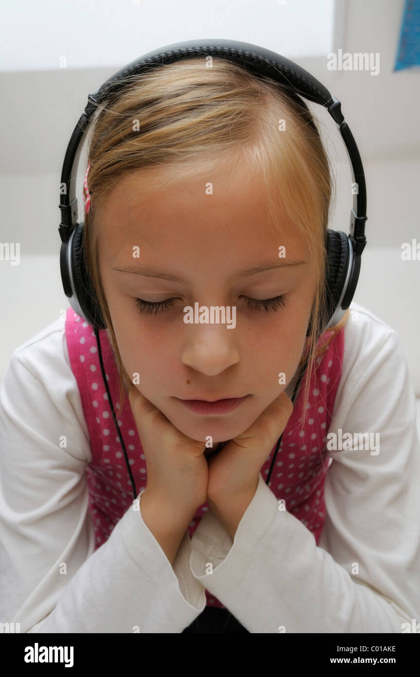 Girl, 9 years, with headphones Stock Photo