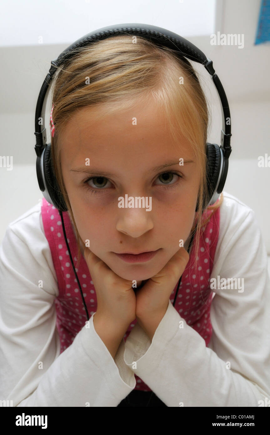 Girl, 9 years, with headphones Stock Photo