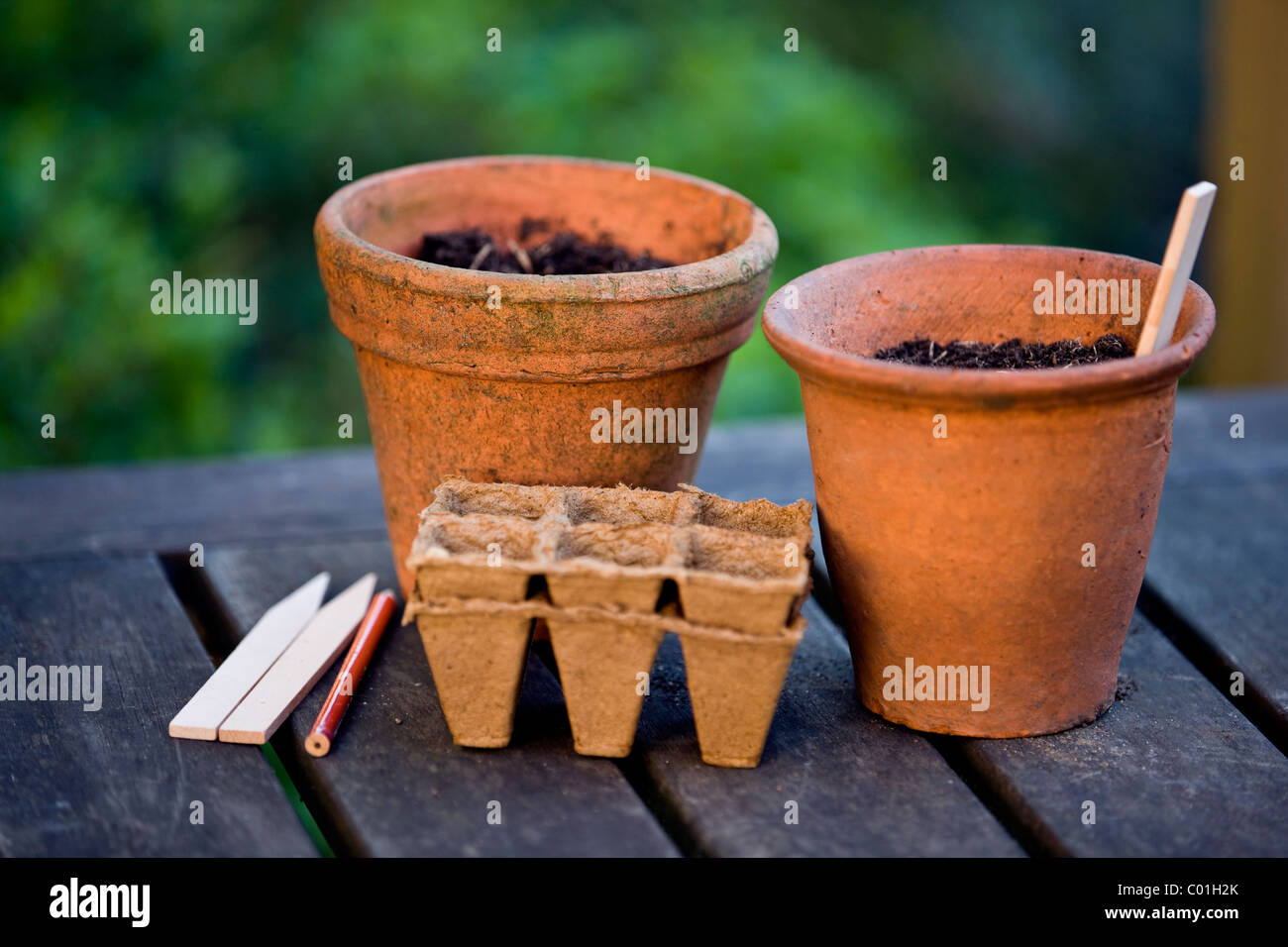 Terracotta plant pots and seed trays on a garden table Stock Photo