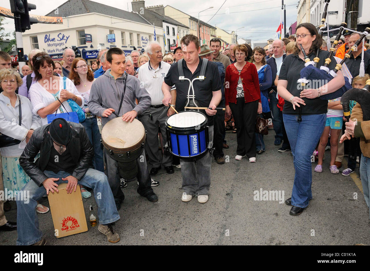 Piper and drummers at an Irish music session in the street, music festival Fleadh Cheoil na hEireann in Tullamore, County Offaly Stock Photo