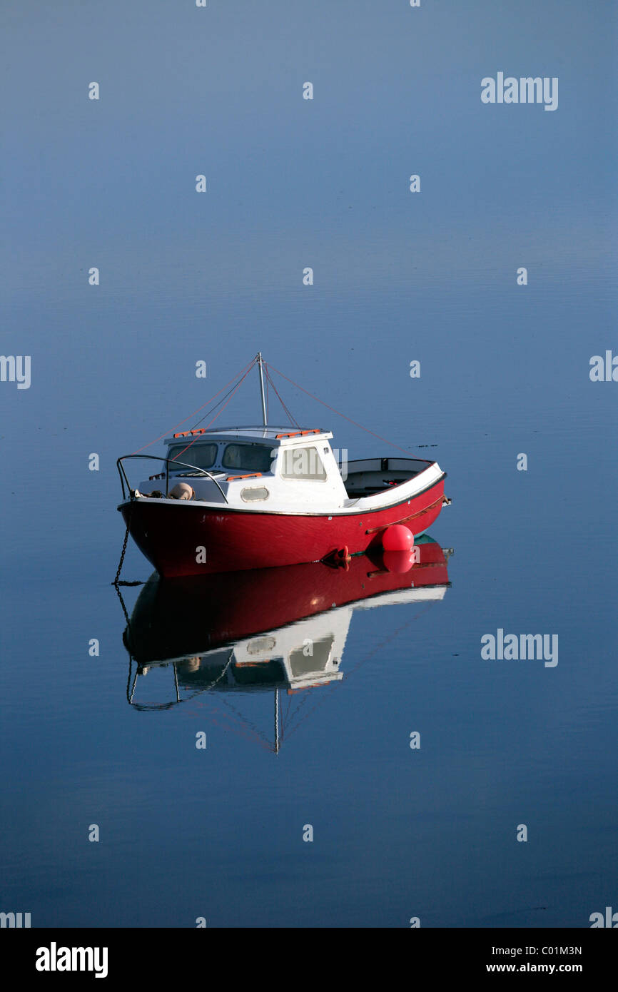 Small fishing boat at anchor on a very calm day, Bangor, North Wales