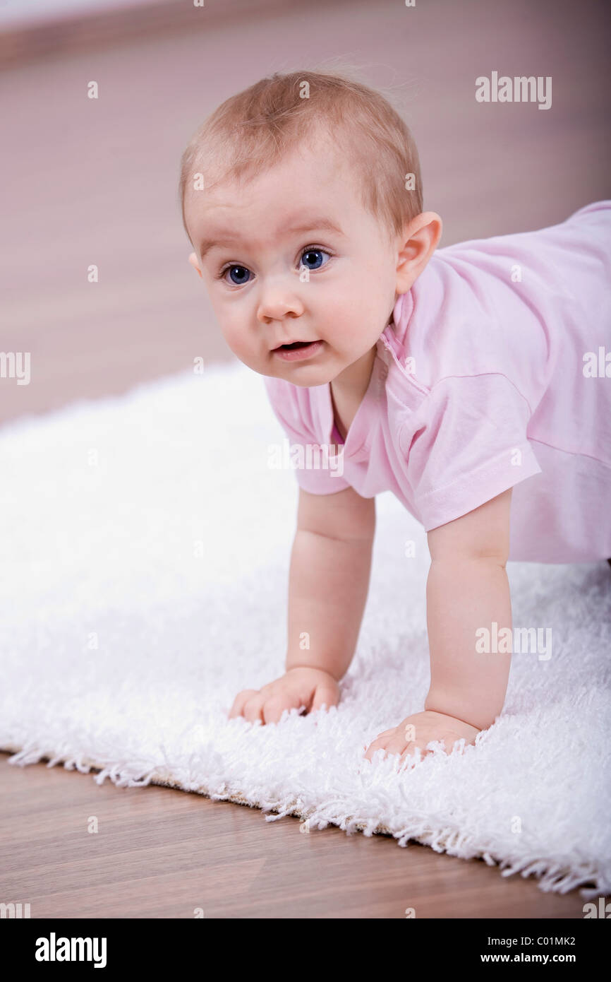 Small baby playing in the living room Stock Photo