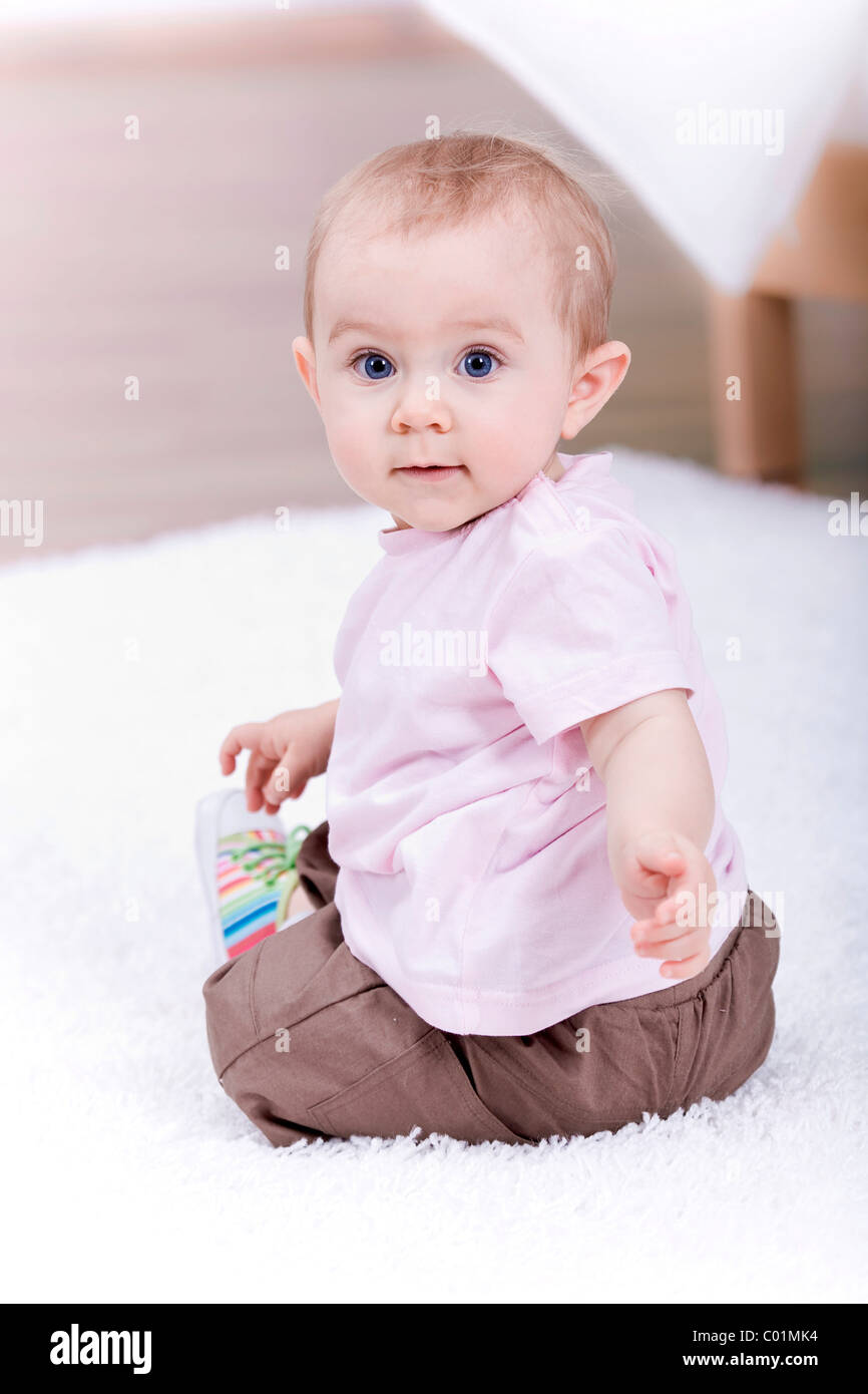 Small baby playing in the living room Stock Photo