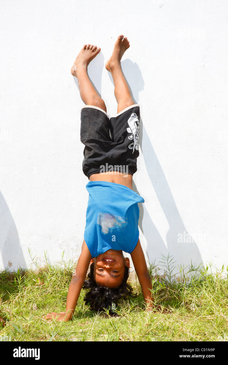 Boy doing a handstand, Fortaleza, Ceará, Brazil, South America Stock Photo