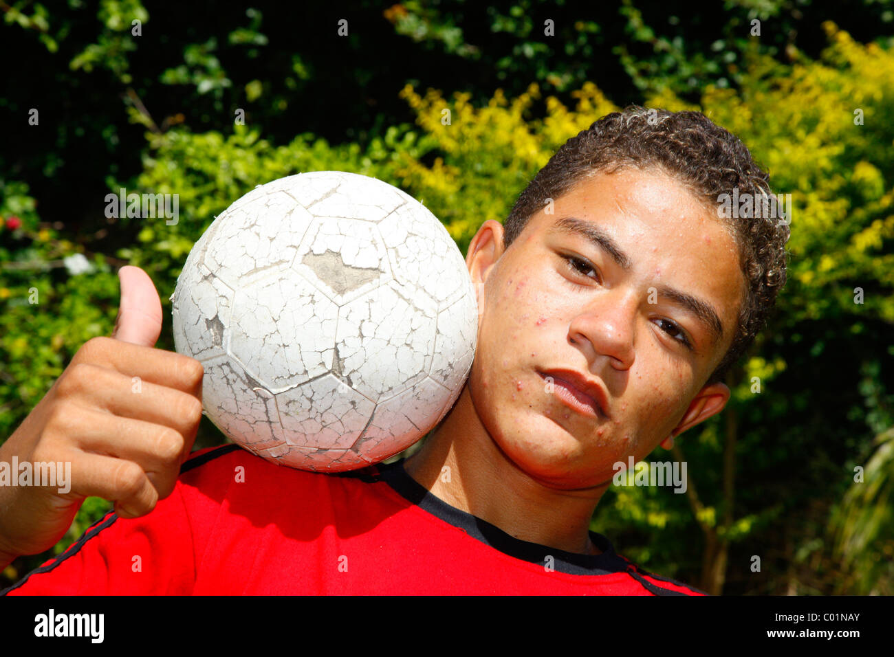 Cool boy with a ball posing lika a macho, Fortaleza, Ceará, Brazil, South America Stock Photo