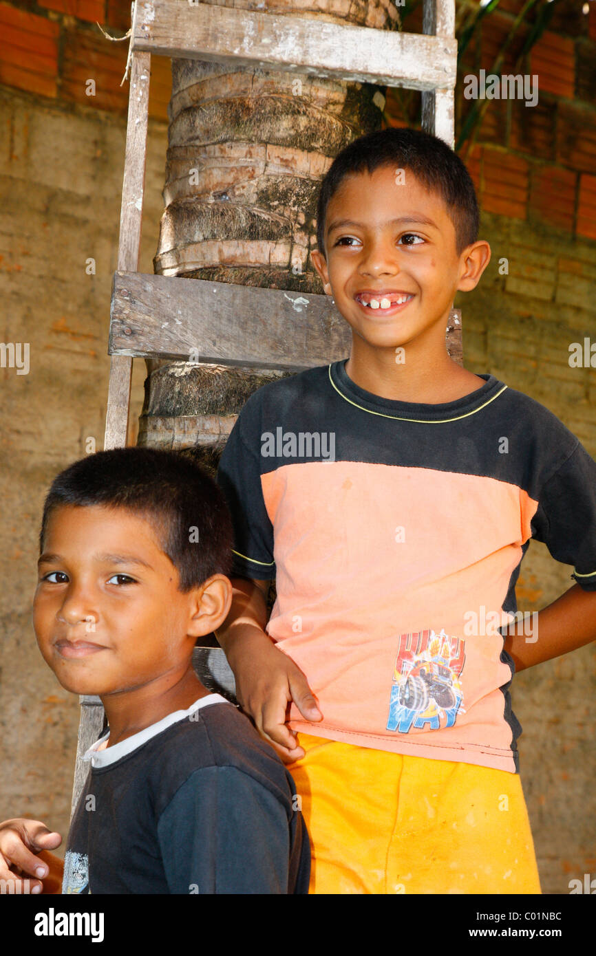 Two boys in front of a ladder, Fortaleza, Ceará, Brazil, South America Stock Photo