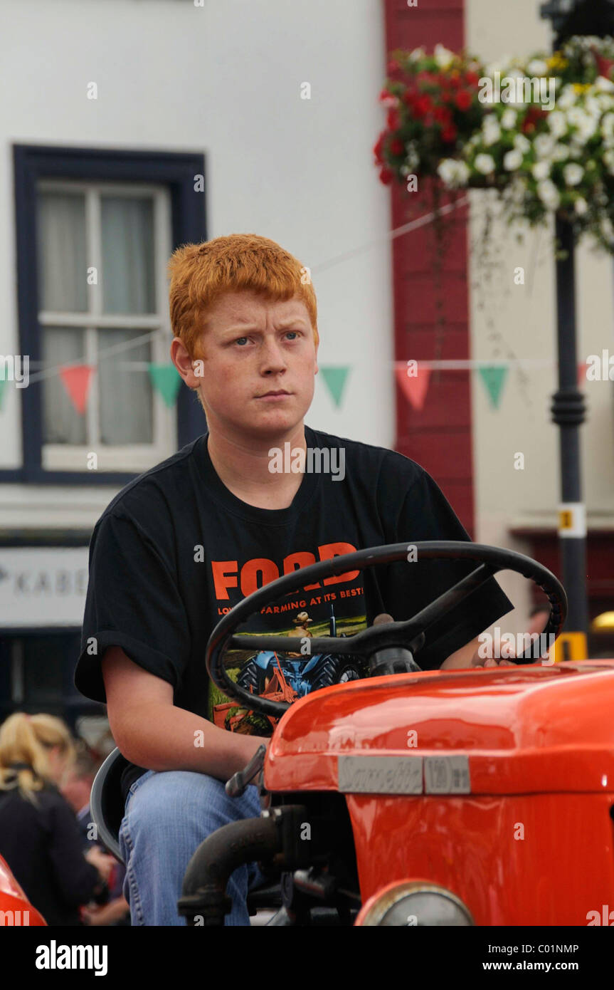 Young Irish farmer on an old tractor, parade of the town festival in Birr, County Offaly, Midlands, Republic of Ireland, Europe Stock Photo