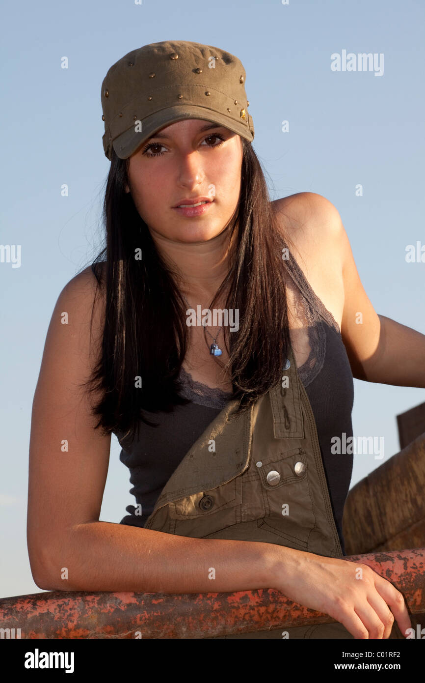 Young woman leaning against a rusty container Stock Photo Alamy