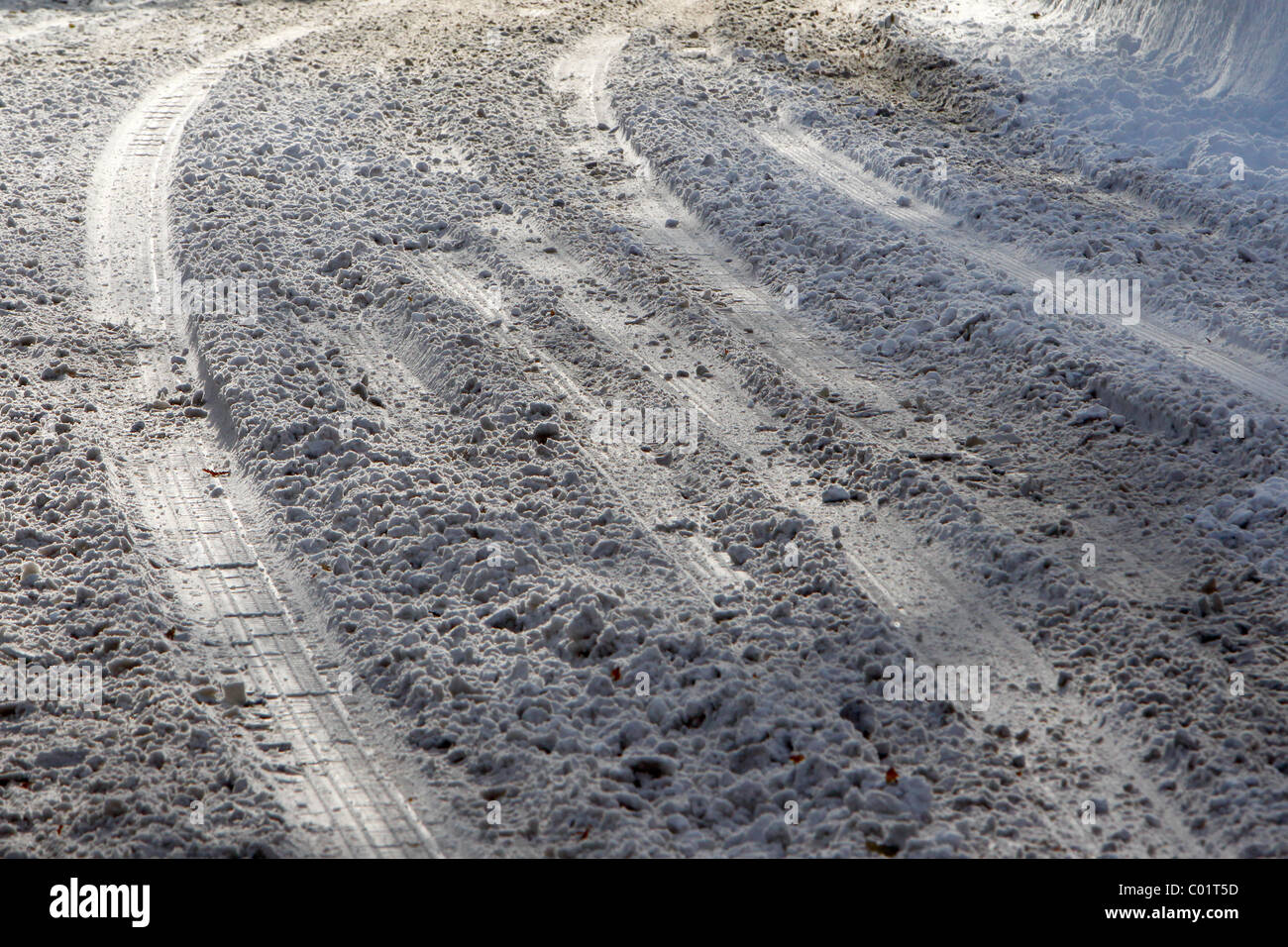 Car tire tracks on a snow covered road Stock Photo - Alamy