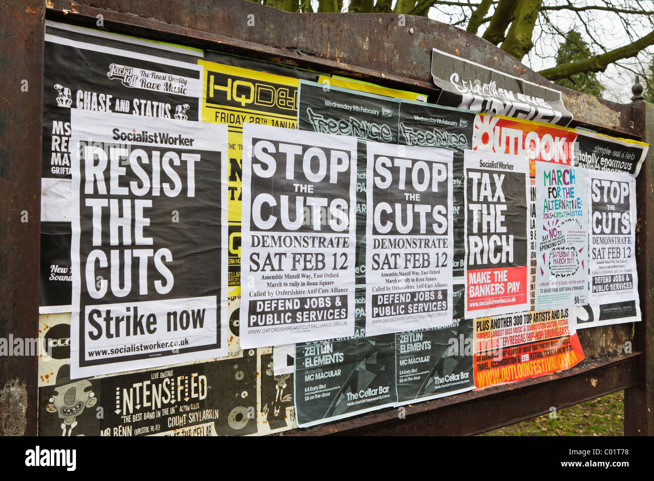 Anti-public spending cuts posters covering a public noticeboard. Oxford, UK. Stock Photo