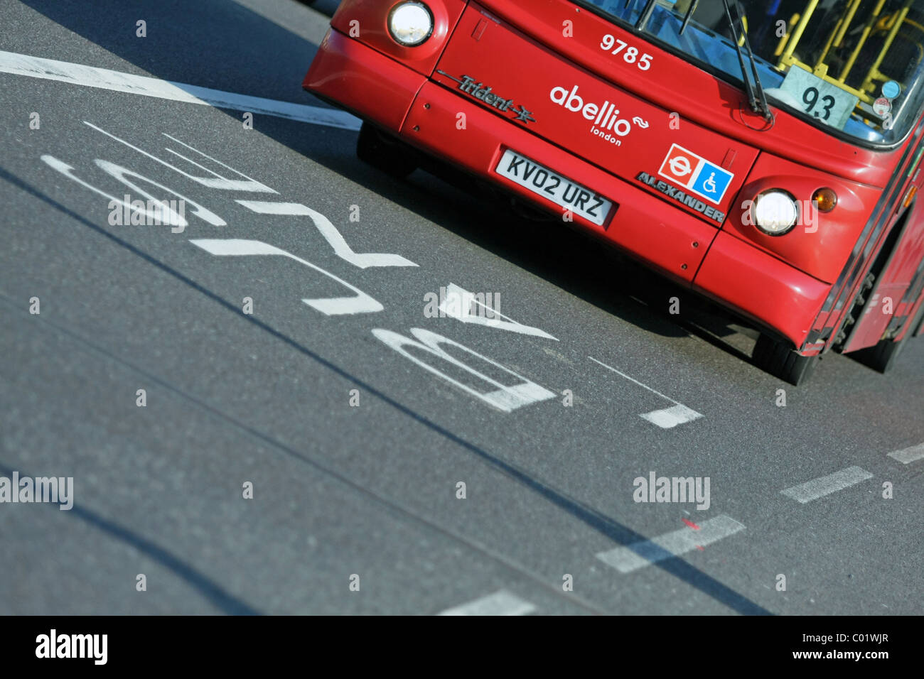 A bus lane sign being approached by a bus in London, England Stock Photo