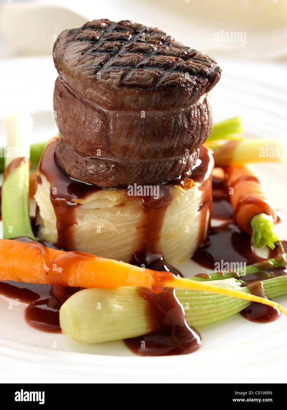Steak tournedo on dauphinoise potatoes with baby carrots baby leeks and