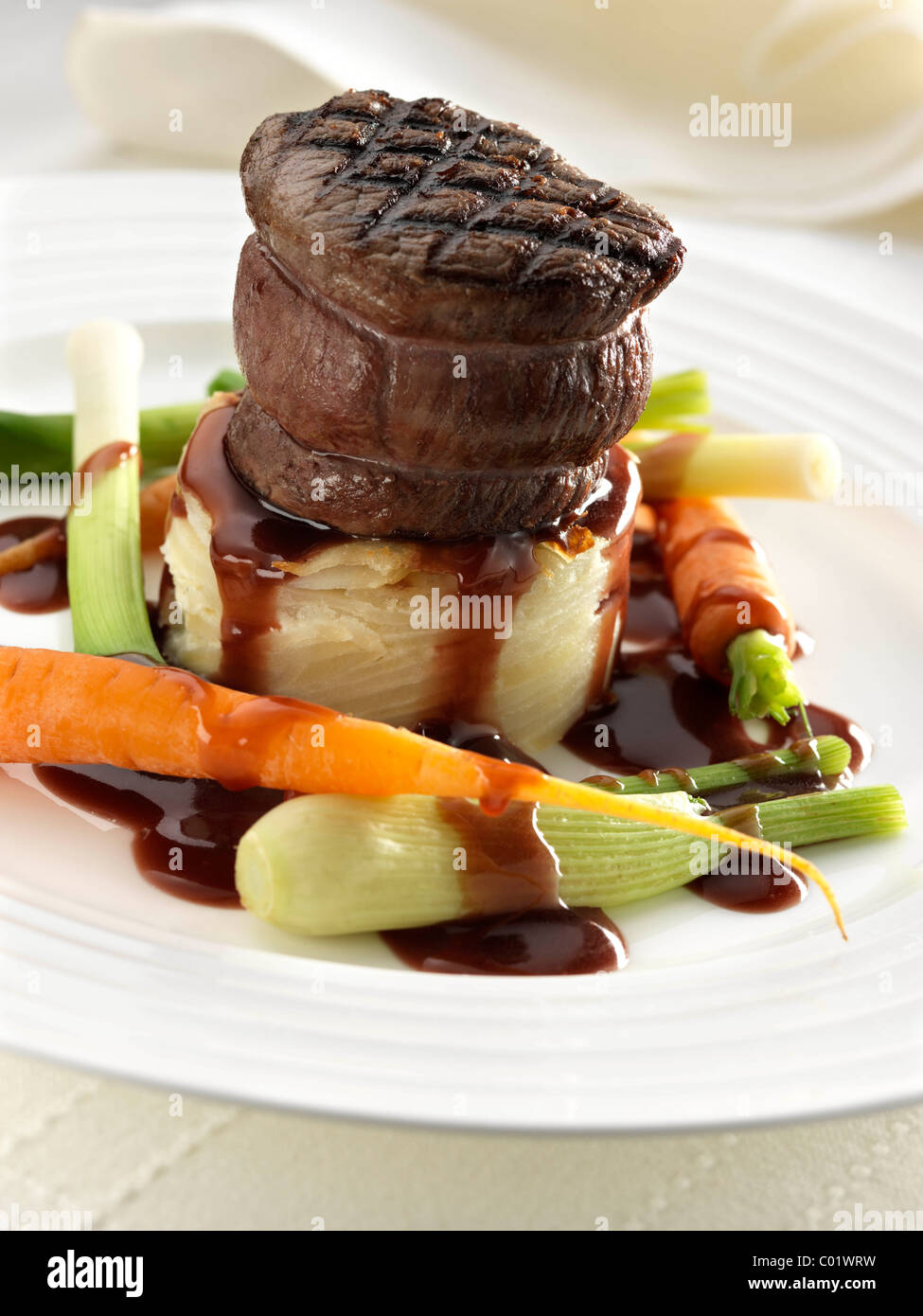 Steak tournedo on dauphinoise potatoes with baby carrots baby leeks and