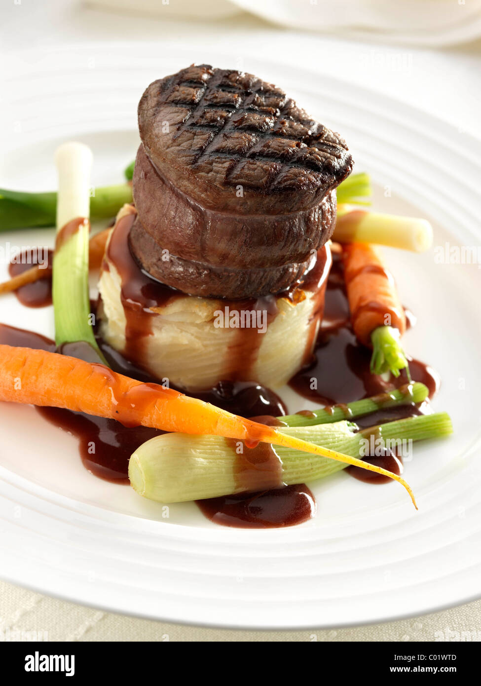 Steak tournedo on dauphinoise potatoes with baby carrots baby leeks and