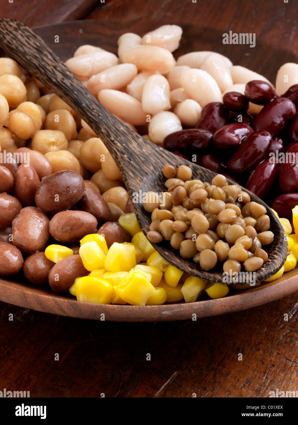A bowl of beans red kidney lentils sweetcorn butter beans borlotti chick peas garbanzo beans Stock Photo