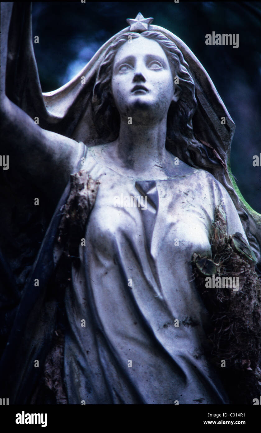 Weathered statue of a woman in a cemetery Stock Photo Alamy