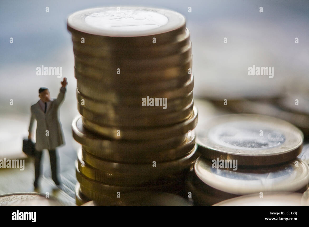 Euro coins and manager figure Stock Photo