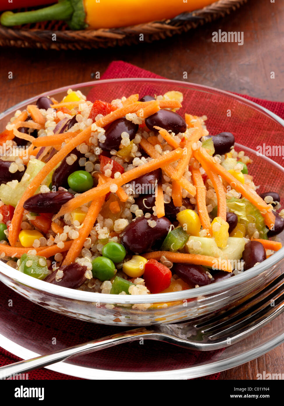 Individual portion of quinoa salad with peas sweetcorn carrots red