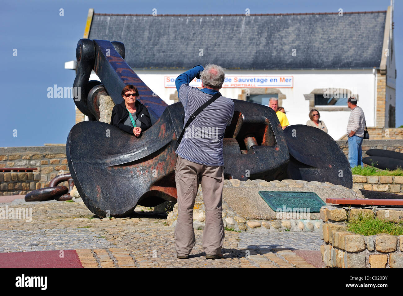 Tourists posing at the anchor of the Amoco Cadiz oil tanker, wrecked
