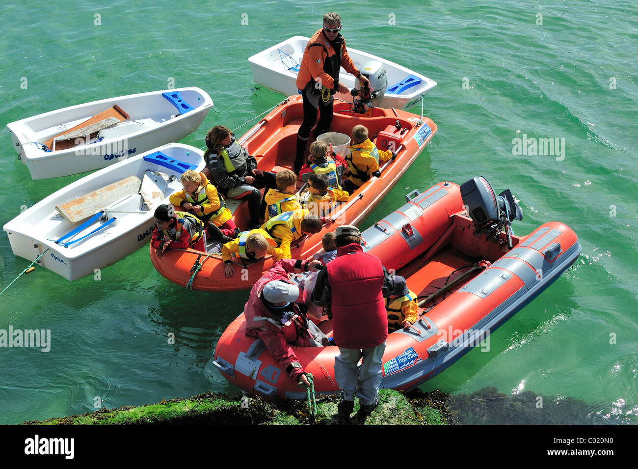 School children with life jackets in dinghy during sailing class Stock Photo Alamy