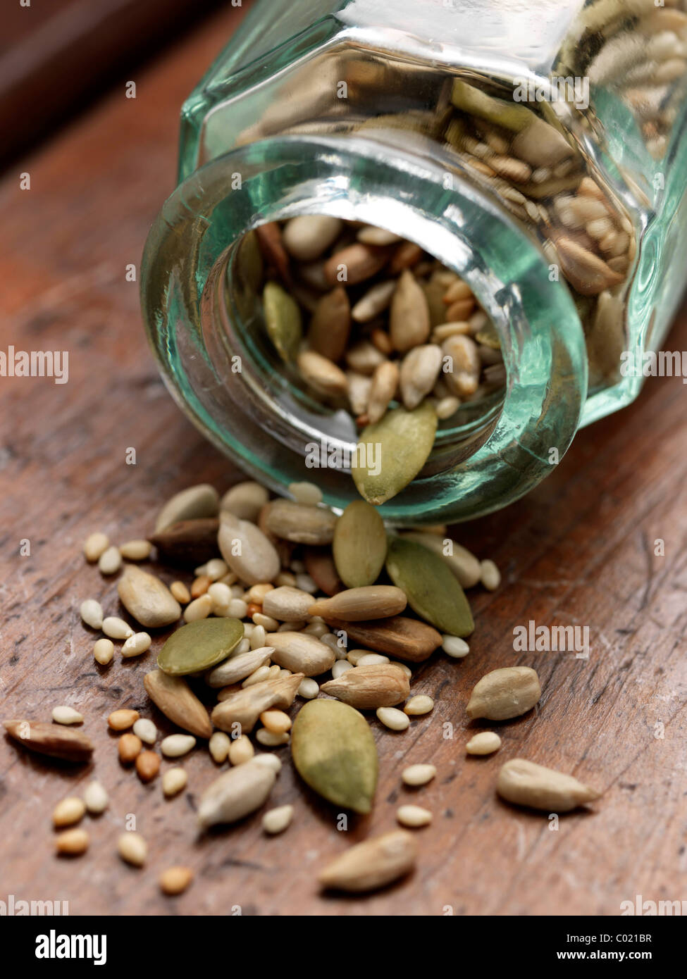 Glass bottle with various seeds Stock Photo