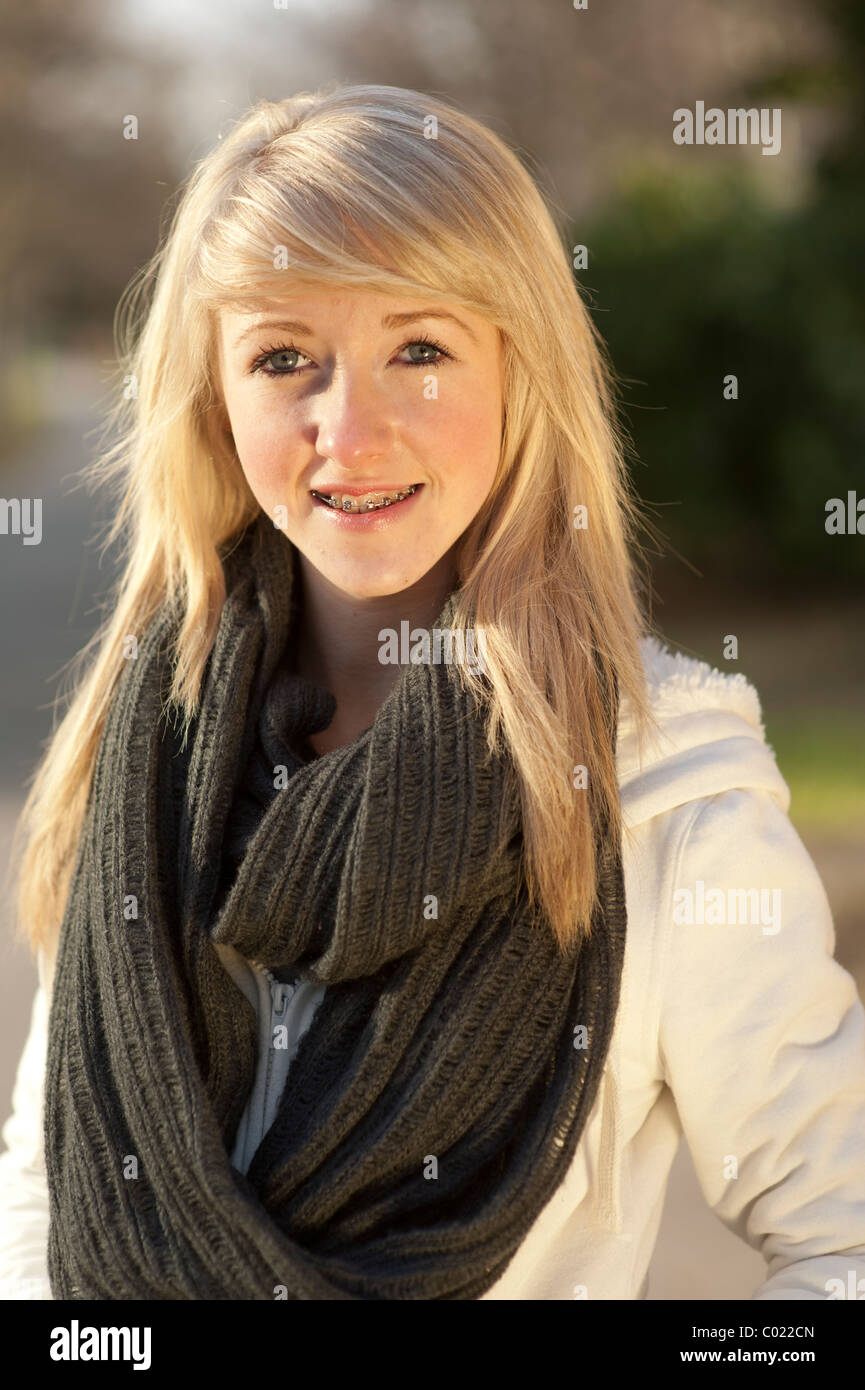 A slim blonde 14 year old teenage girl, with braces on her teeth UK Stock Photo