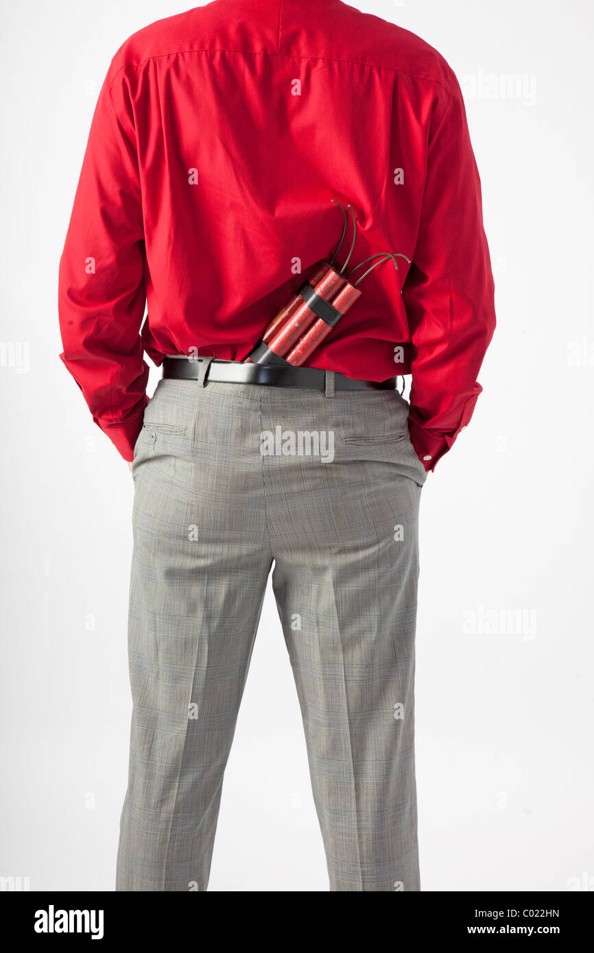 back of man with TNT or dynamite hidden in back of pants, he has his hands in pockets. Stock Photo