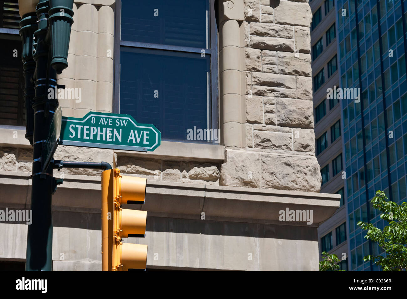 Street sign and traffic stop lights at Stephen Avenue 8th SW in downtown Calgary, Canada Stock Photo